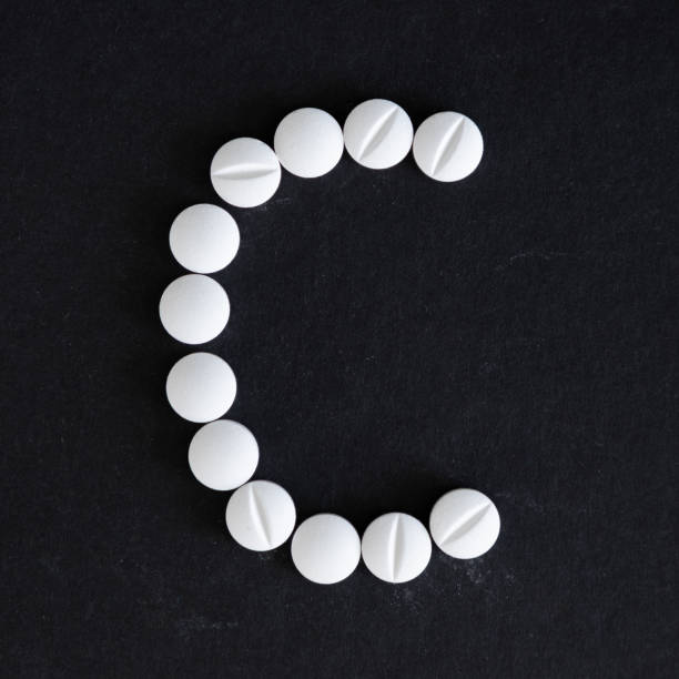 letter C made of vitamin pills letter C made of vitamin pills vitamin photos stock pictures, royalty-free photos & images