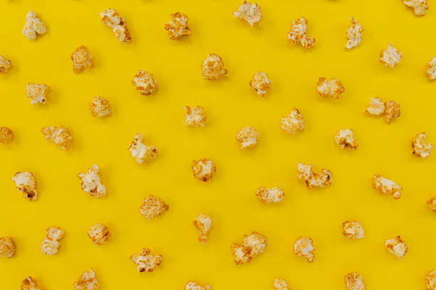 istock pattern of caramel popcorn on yellow, sweet snacks 1367901500