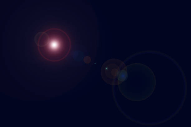 istock Shinny flash Lens flare looking like multi-colored cosmic spheres of light and reflected light in various sizes centered dark navy blue background 1367902179