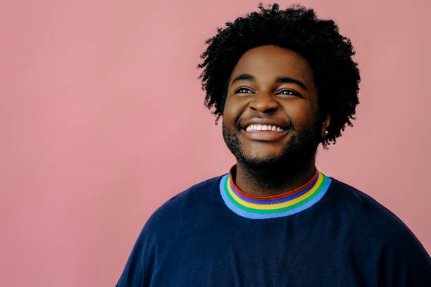 istock young happy african american man posing in the studio over pink background 1367902299