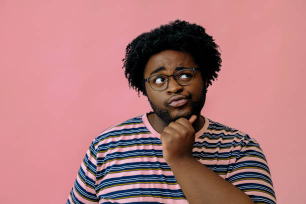 istock young happy african american man posing in the studio over pink background 1367902565
