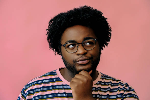 istock young happy african american man posing in the studio over pink background 1367902570