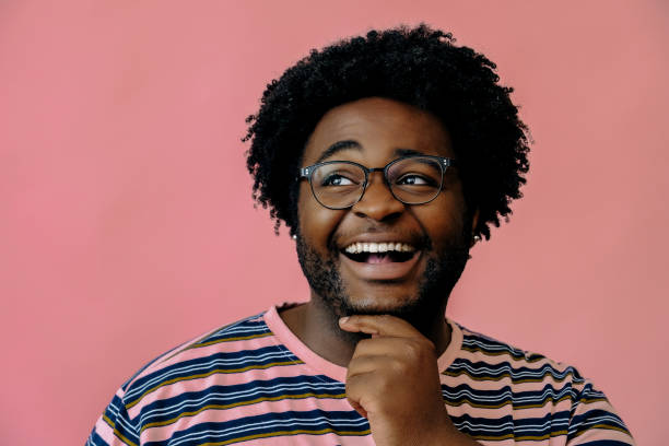 istock young happy african american man posing in the studio over pink background 1367902580