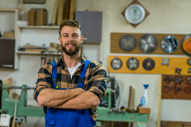 istock Portrait of smiley handsome carpenter at his workplace 1367903416