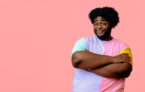 istock young happy african american man posing in the studio over pink background 1367904126