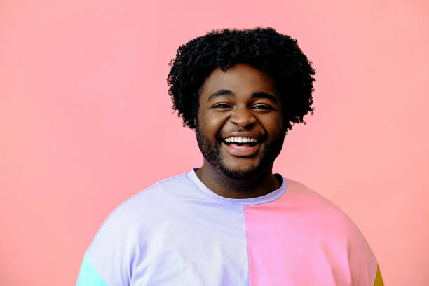 istock young happy african american man posing in the studio over pink background 1367904133