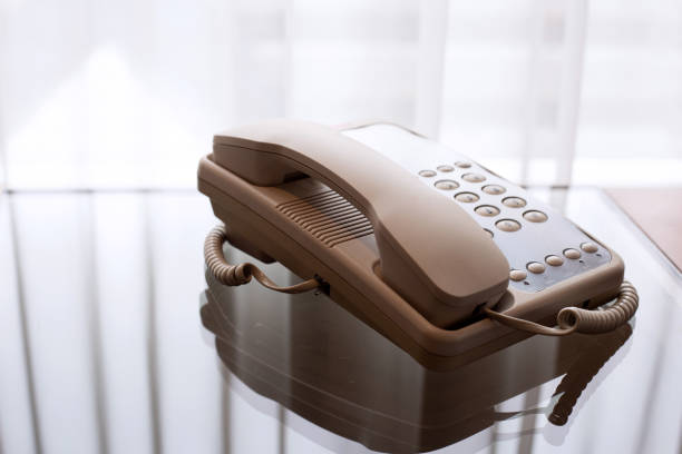 istock Landline phone on glass table 1367905284