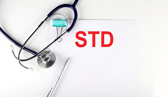 STD text written on the paper with a stethoscope. Medical concept.