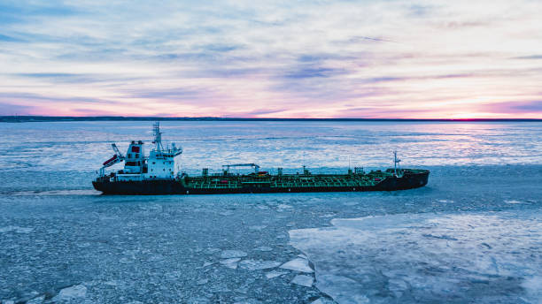 istock Cargo ship sailing through cold ocean water with broken ice 1367906553