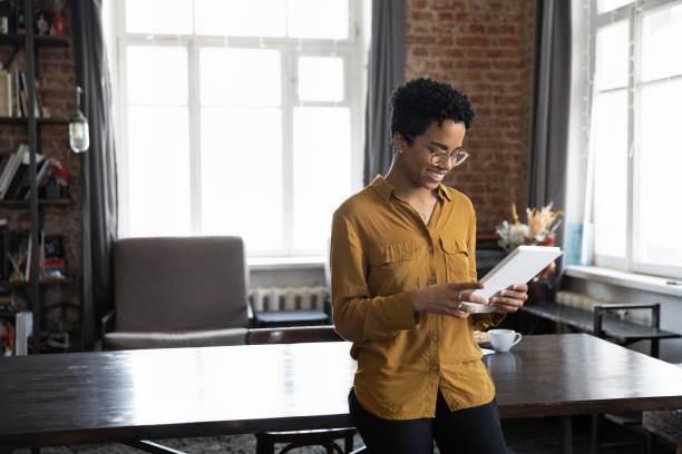 istock Happy young African American woman using digital tablet. 1367906987