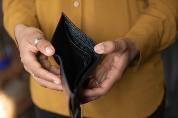 istock Close up young African American woman holding empty wallet. 1367907023