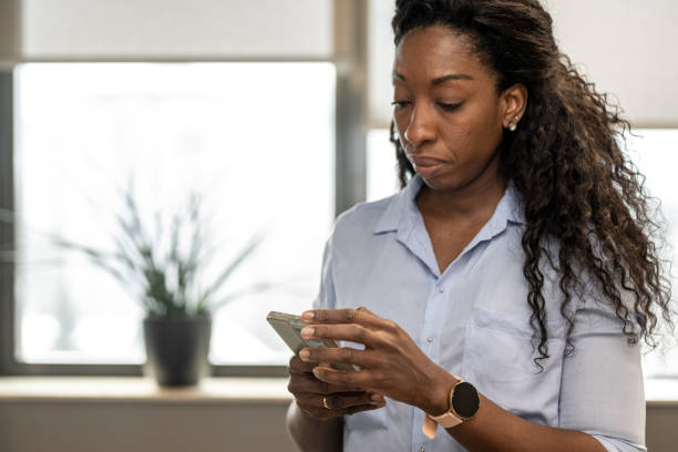 istock Black woman using a smartphone in an office 1367909016