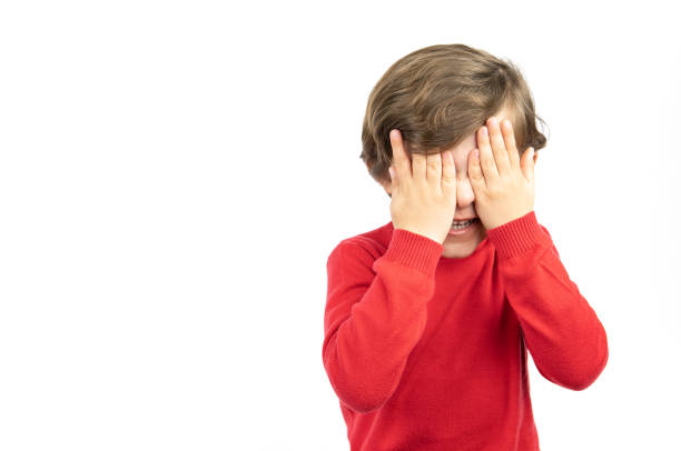 istock Little boy in red sweater, angry on white background 1367909107
