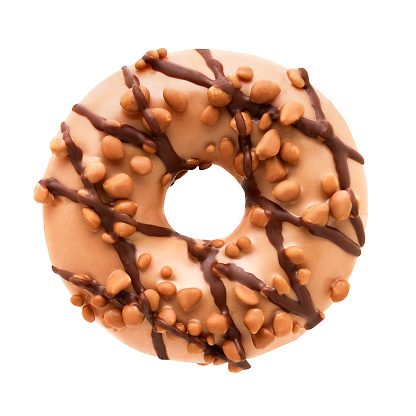 Donut in milk chocolate glaze with nuts isolated over white background with clipping path. Top view