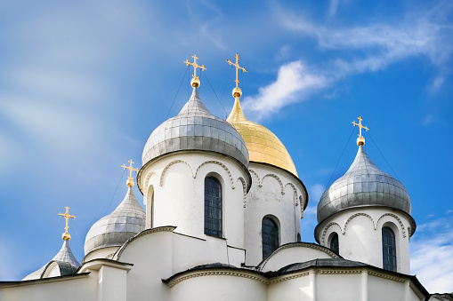 The domes of the Orthodox Church against the blue sky. Crosses on the domes of the church. Russia