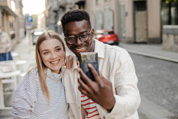 istock Friends taking selfie on the street 1367910127