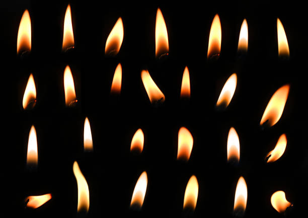istock candle lights isolated on a black background 1367910304