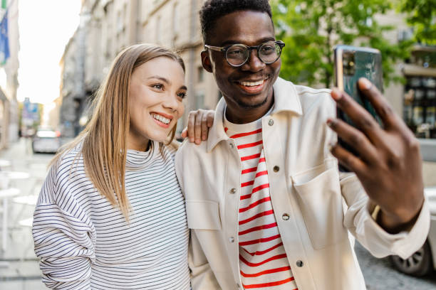 istock Friends taking selfie on the street 1367910358