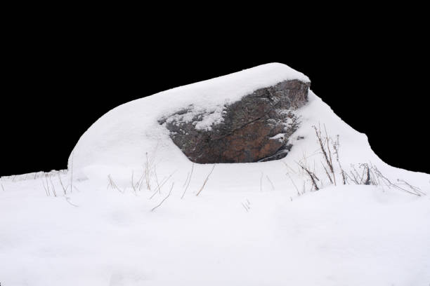 istock natural stone in snow isolated on black background 1367913041