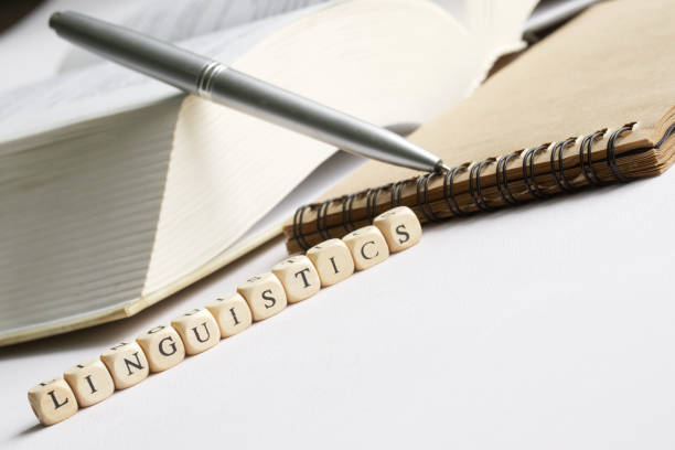 istock Word linguistics next to a fountain pen, open book and notepad. Humanities study concept. Academic subject. Literature, creative writing and linguistics. White background. Selective focusing 1367914076