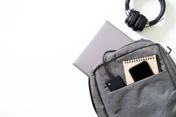 istock Gray city backpack with laptop, smartphone, notepad, external ssd and headphones on white background. Lifestyle concept with gadgets. Ð¡oncept of a modern student's backpack 1367914110