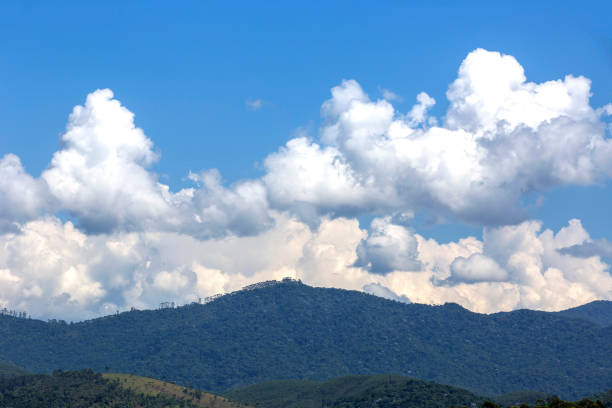 Natural landscape: clouds in dramatic formation over the chain of hills, with blue sky. Serra da Mantiqueira, Sao Paulo state, Brazil