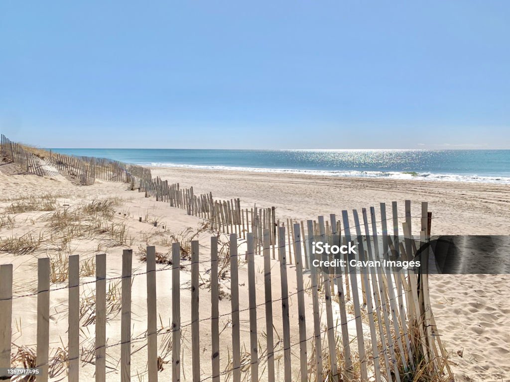 Sunny Day at Beach with Fenced Off Dunes, East Hampton, NY, US Sunny Day at Beach with Fenced Off Dunes, East Hampton, NY, US in East Hampton, New York, United States The Hamptons Stock Photo