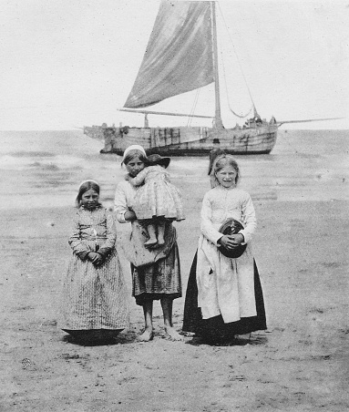 Children stand in front of their father's fishing boat at Scheveningen the Hague, Netherlands (Holland). Photo by Dr. Charles Mitchell commissioned for an 1894 book about Holland. Source: Original edition is from my own archives. Copyright has expired and is in Public Domain.