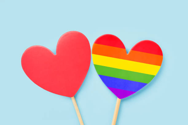 istock Red and rainbow color hearts on a light blue backdrop. Valentines day background. LGBT concept 1367920120