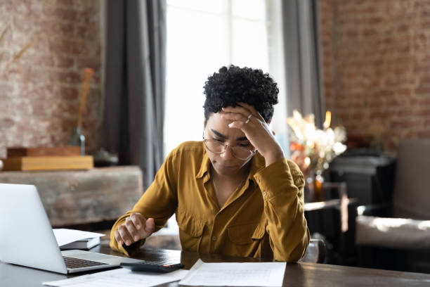 istock Unhappy young African American woman having financial problems. 1367920239