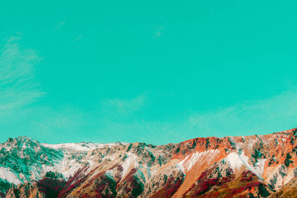 Row of mountain peaks. Smooth celestial sky background.