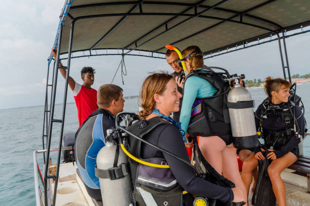 the big group of divers makes the final preparations aboard a boat, talking, and waiting for diving. - men latin american and hispanic ethnicity southern european descent mature adult imagens e fotografias de stock