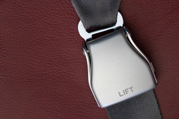 istock airplane seat belt closed in red leather seat - selective focus. 1367928687