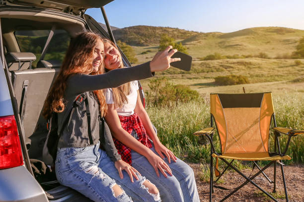 istock Teenagers taking selfie on a road trip 1367929625