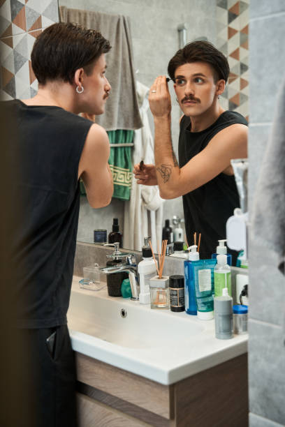 istock Male model applying brow gel for eyebrows while preparing to the walking 1367930120