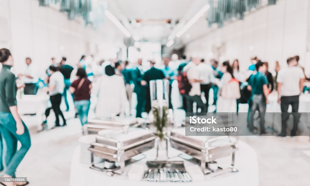Blured image of businesspeople at coffee break at conference meeting. Blured image of businesspeople at coffee break at conference meeting. Business and entrepreneurship. Conference - Event Stock Photo