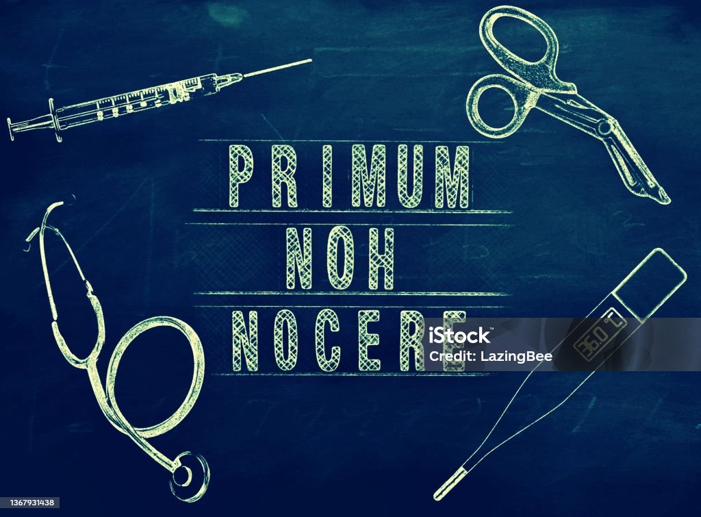 'Primum Non Nocere' in Chalkboard Lesson Style The Latin Phrase 'Primum Non Nocere' is part of the Doctors Hippocratic Oath. The premise is it may be better to not do something or to do nothing at all at the risk of causing more harm than good. This is in Chalkboard Style for a concept of a lesson in Healthcare and Medicine, learning the principle medical ethics of the Doctor's Medical Oath. Healthcare And Medicine Stock Photo