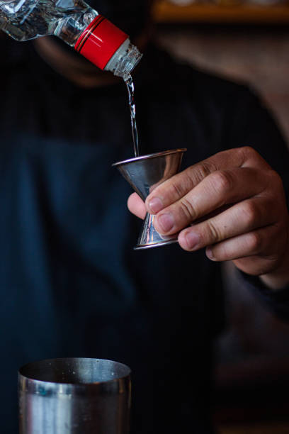 istock Hand of bartender preparing a cocktail at the bar 1367933385