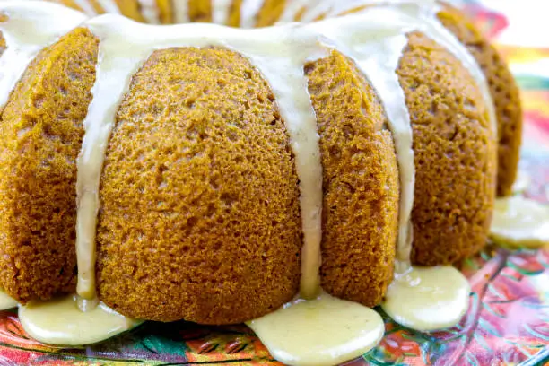 A pumpkin bundt cake with maple syrup icing.