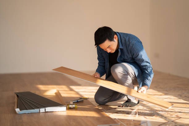 istock Carpenter is working on SPC flooring inside the house. 1367942471