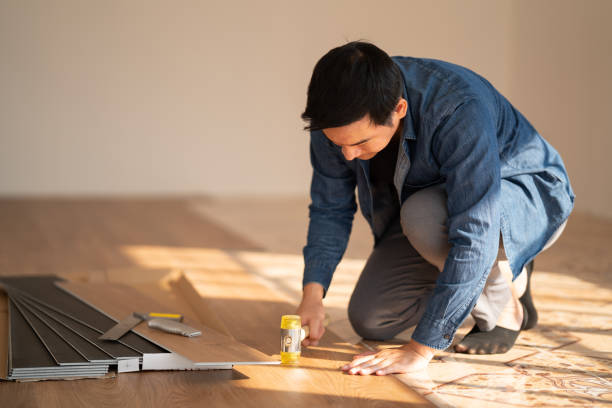 istock Carpenter is working on SPC flooring inside the house. 1367942482