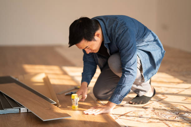 istock Carpenter is working on SPC flooring inside the house. 1367942580