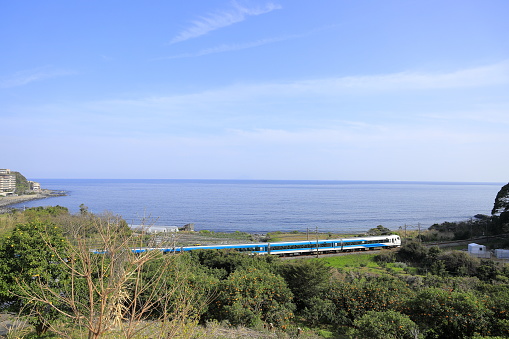 train running by seaside of Izu, Shizuoka, Japan (Odoriko, E257 series)