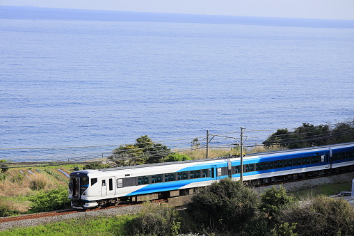 train running by seaside of Izu, Shizuoka, Japan (Odoriko, E257 series)