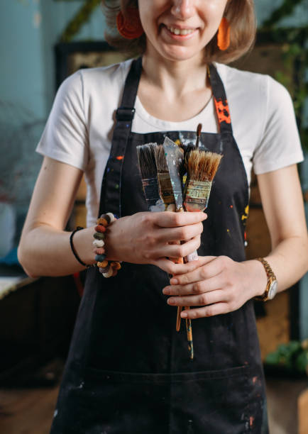 istock Woman artist creating canvas with paint in studio 1367946267
