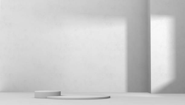 istock Empty studio with podium and spot light from window. Gray color. Background design for product display and presentation. 1367946322