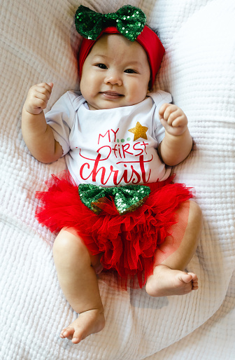 Portrait of happy Asian baby wearing Christmas dress.