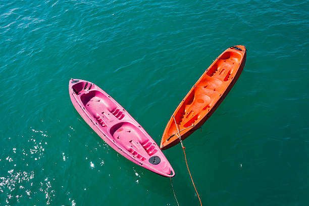 two colorful kayaks in the sea