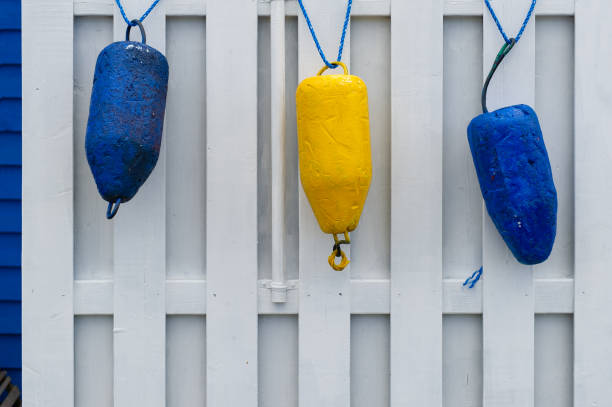 Colorful buoys hanging on a shed stock photo
