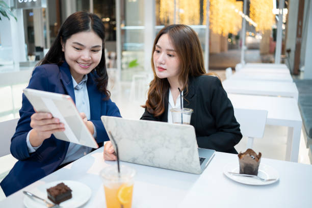 istock Business women Making smart Talk about work outside the cafe seriously. 1367950869